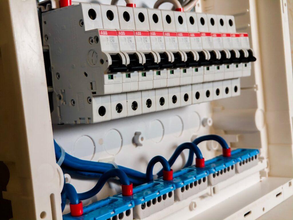 Modern Appliances vs Vintage Wiring 2 modern smart kitchen with high-tech appliances and electrical panel visible in background - is your electrical system safe